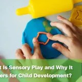 Child using playdough and colourful tools during a sensory play activity.