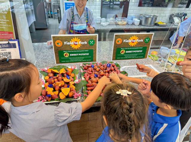 colourful-sweet-potatoes Students excitedly reaching for colourful sweet potatoes during international school lunch Discovery Day