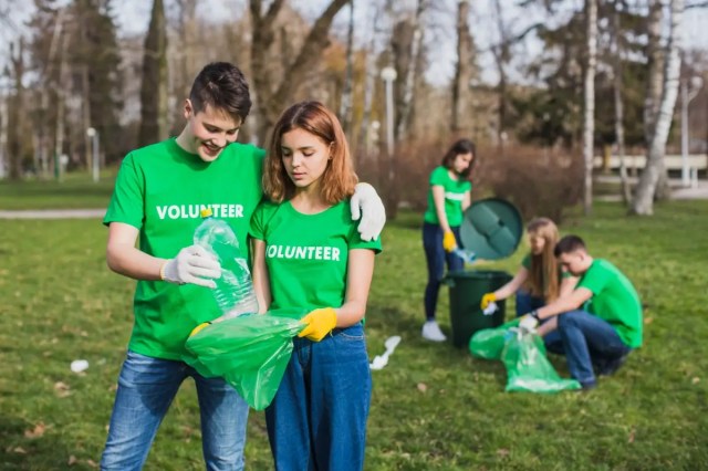 Students participating in community service and character development through a park clean up.