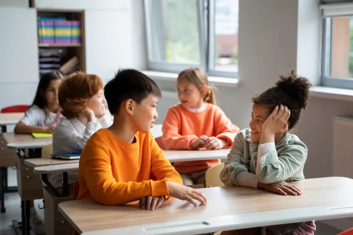 Students discussing ideas in the classroom to develop critical thinking skills.