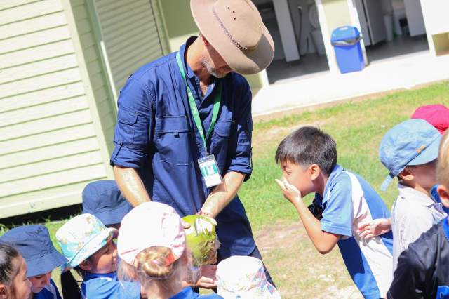 explore-homegrown-school Students gather with curiosity and excitement to explore homegrown school food in the garden