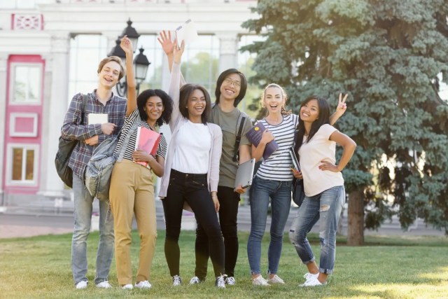 higher-education-planning Students celebrating on campus after university guidance and higher education planning.