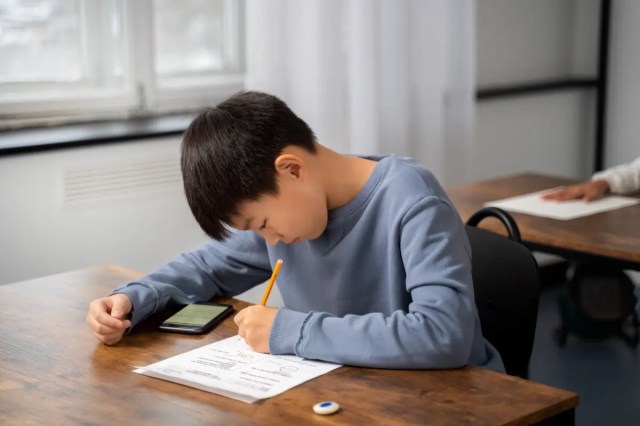 mindful-help-kid-learning Child demonstrating focused learning in the classroom, showing how mindfulness helps kids learn by improving concentration.
