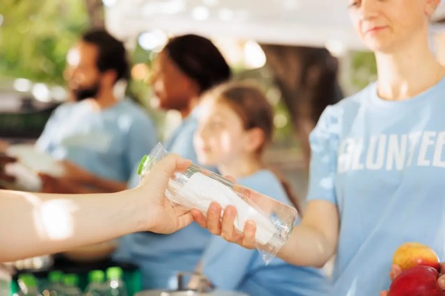 Volunteer distributing supplies during a service learning in schools activity.