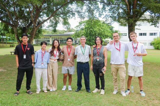 smiling-and-reconnecting-with-teacher A group of St. Andrews International School alumni return to visit the Green Valley campus, smiling and reconnecting with a teacher