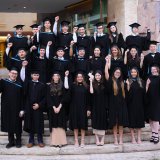Group of St. Andrews international school alumni in graduation gowns celebrating their achievements before beginning global careers and studies