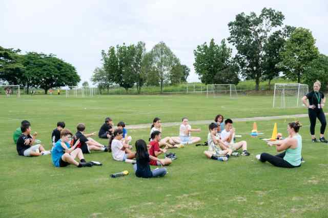 Students enjoy outdoor stretching on Green Valley’s fields during a way to Wellness program session.
