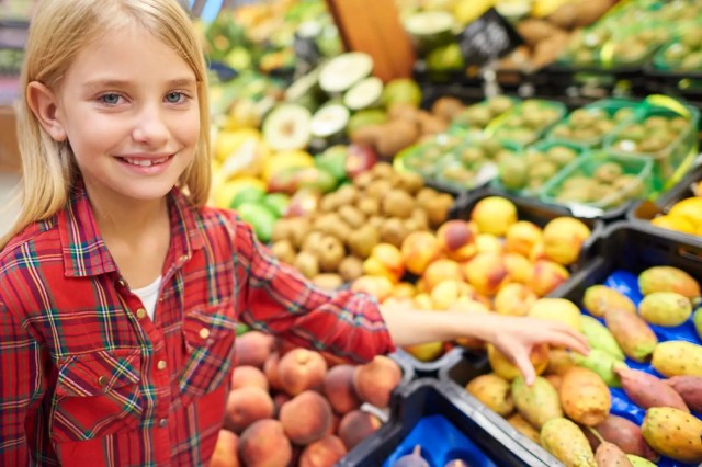 Student exploring fresh produce at a local market.