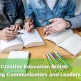 Students collaborating on a classroom project, demonstrating creative education benefits through teamwork and discussion.