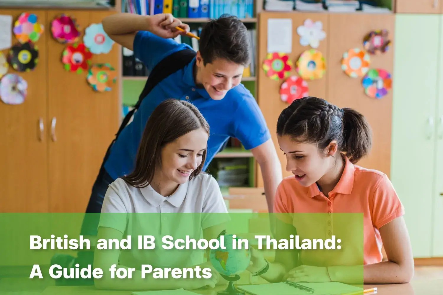 Students exploring a globe together in a British and IB School in Thailand.