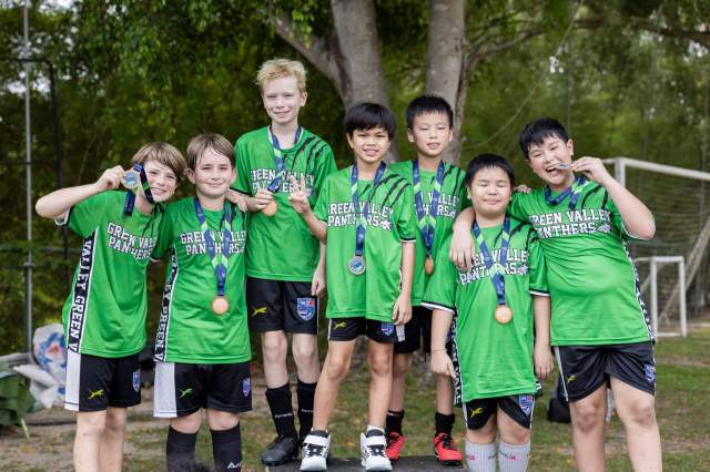students-proudly-showing-medals School sports team students proudly showing medals after winning in interschool competitions