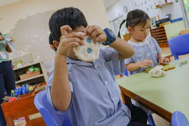 Child explores textures and shapes through creative play revealing natural interests through unstructured activity