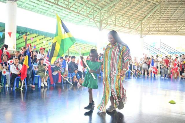 diversity-unity A Jamaican student waving her national flag in the International Day parade at Green Valley, showing diversity and unity.