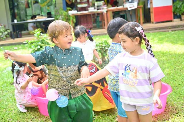 dressed-cultural-outfits Young Green Valley students celebrate International Day outdoors, dressed in cultural outfits and sharing smiles