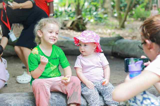 family-involvement-boosts-early-education Young children enjoying outdoor learning with parents’ support, showing how family involvement boosts early education