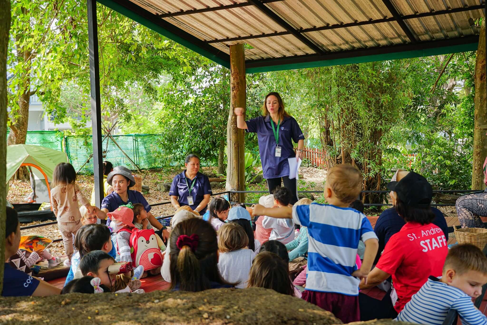 Forest School practitioners lead an outdoor session at St. Andrews Green Valley, supporting young learners through nature-based exploration and personalised guidance.