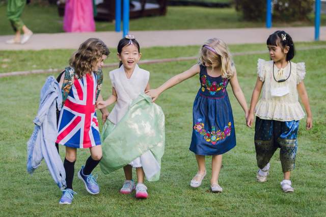 friendship-and-unity Four young students from different cultural backgrounds walk together, showing friendship and unity.