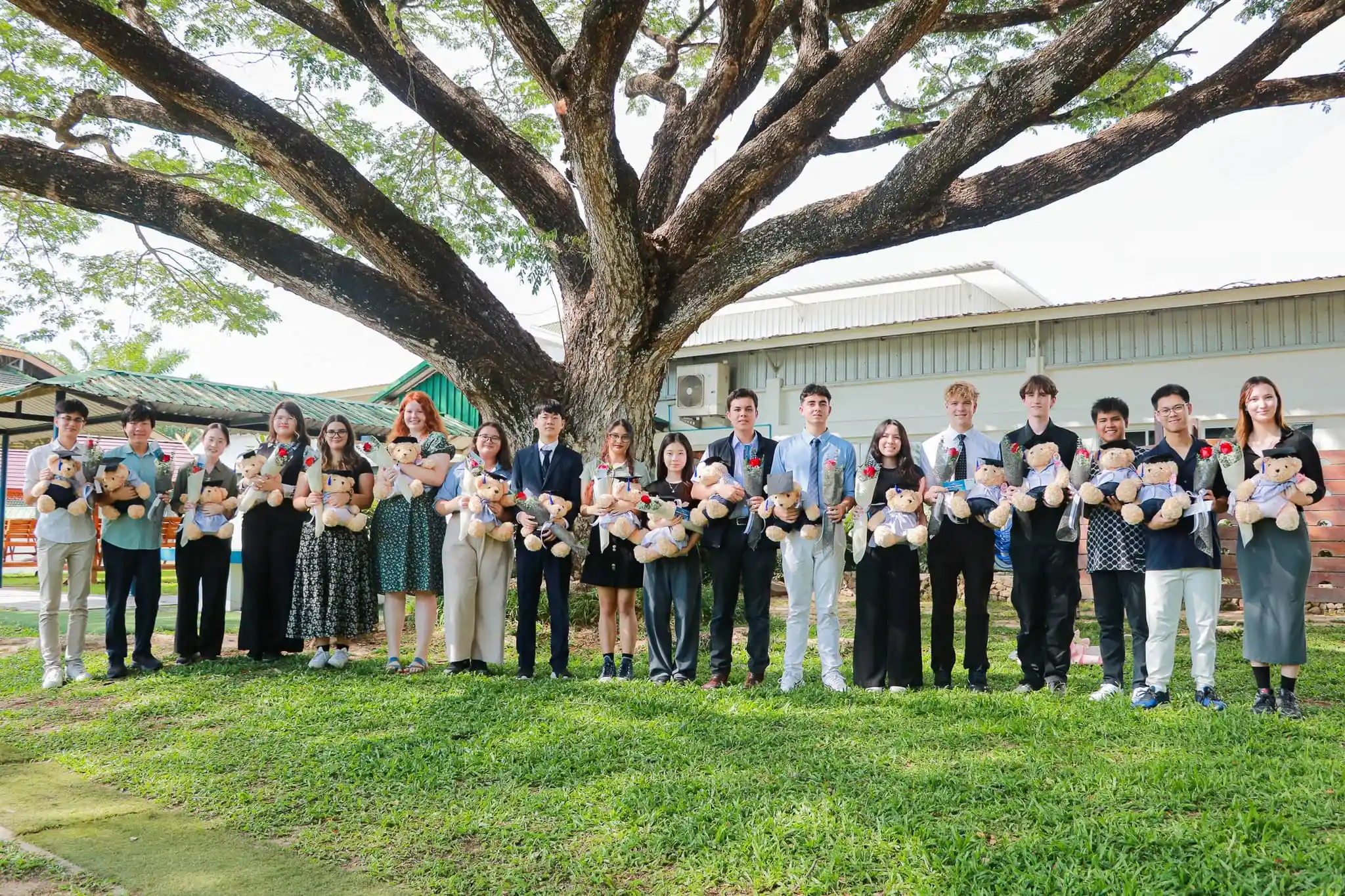IB Class of 2025 graduates at Green Valley holding bears and flowers, ready to pursue diverse futures worldwide