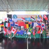 A group of diverse St. Andrews Green Valley students stands together in a powerful display of community.