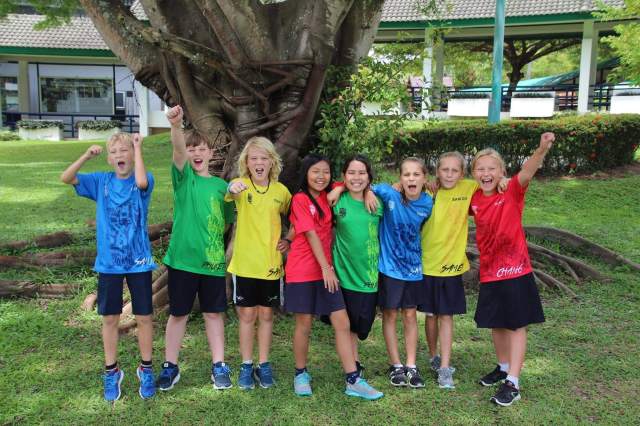house-system Students from different houses in the house system are enjoying and cheering together in the school garden