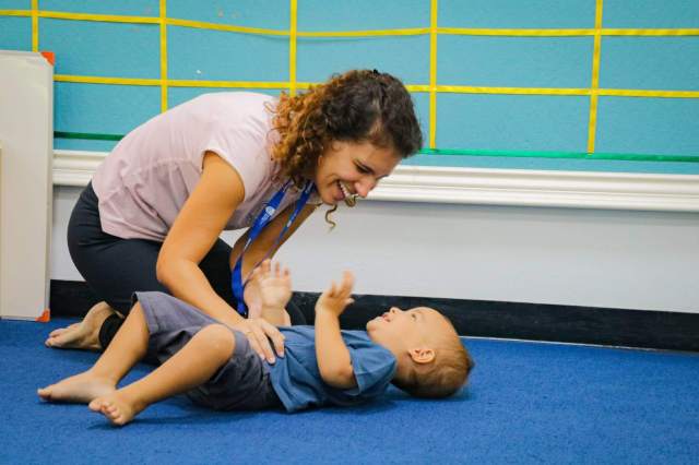 Teacher shares a joyful moment with a young child during play-based learning, reflecting Green Valley’s supportive and caring Early Years environment.
