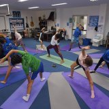 a group of St. Andrews Green Valley students practicing yoga as a part of the school's wellbeing programme.
