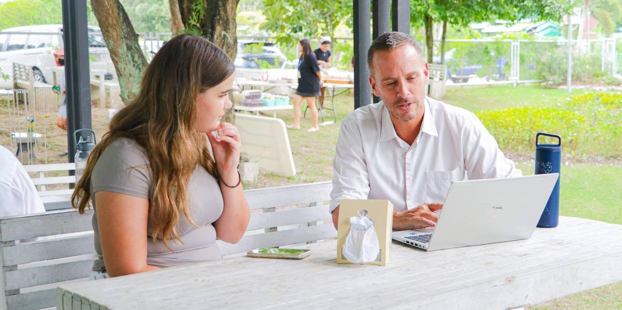 A student consults with a teacher on one-on-one Green Valley's university placement programme.