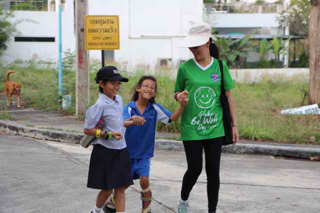 well-being-and-support Green Valley staff and students walk with the injured girl while laughing together, displaying well being and support.