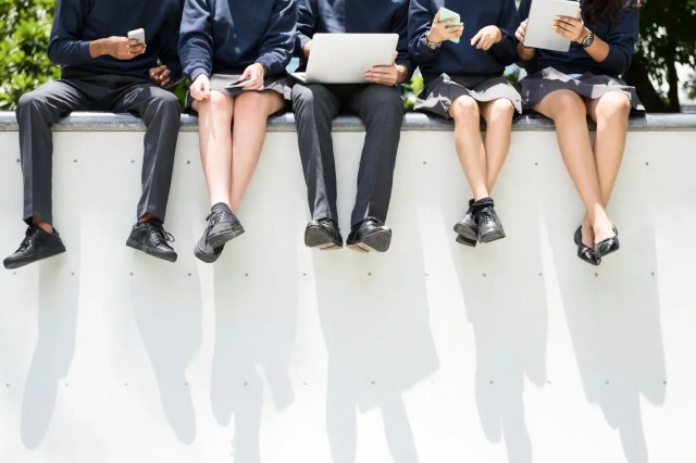 Students collaborating outdoors to talk about how to get into Ivy League schools.